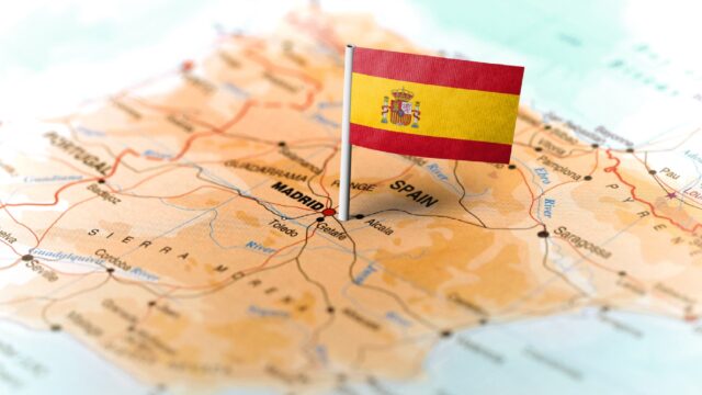 The flag of Spain pinned on the map.