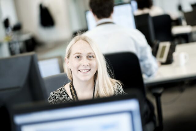 An apprentice sat at a computer.