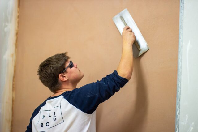 A student plasterer practicing.