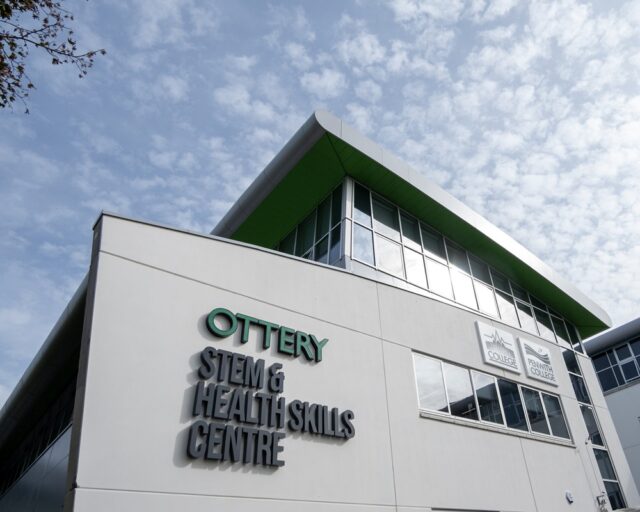 A picture of the outside of the Ottery building. There is a blue sky scattered with clouds.