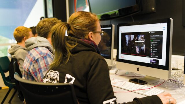Students sit at computers in the media suite.