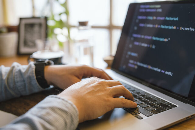 Hands typing on a laptop.