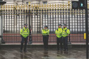 Four police officers stood outside the gates of Buckingham Palace.