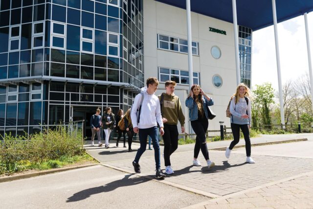 Students walking out into the sunshine from the Zennor building at Penwith College.