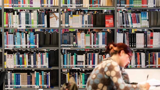A student sits in the library at the University Centre Truro & Penwith.