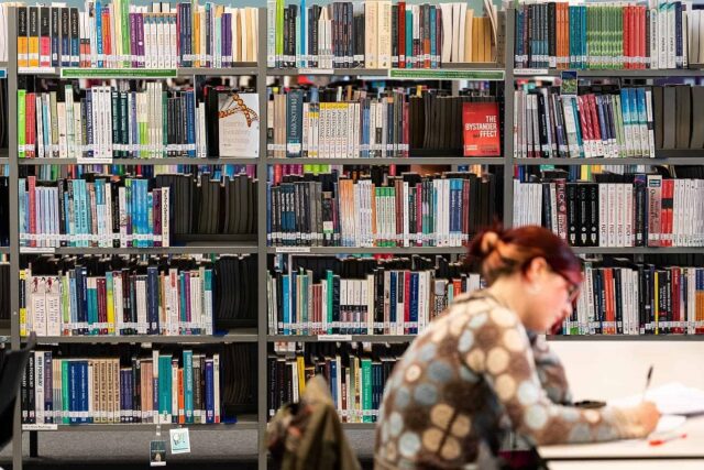 A student sits in the library at the University Centre Truro & Penwith.