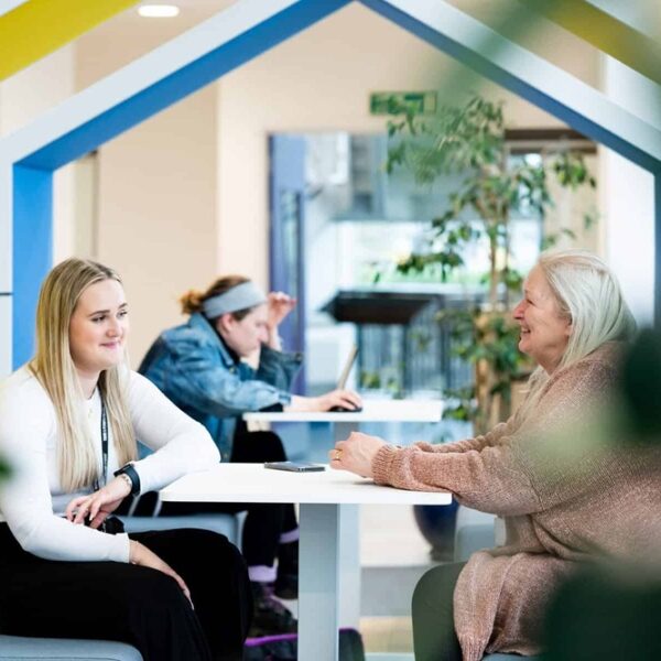 Two students sitting and chatting at the University Centre Truro & Penwith
