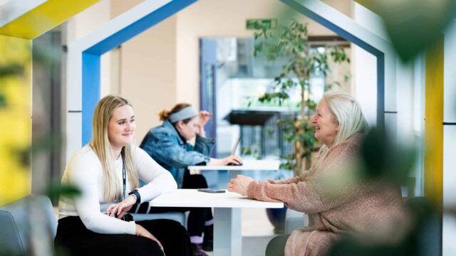 Two students sitting and chatting at the University Centre Truro & Penwith