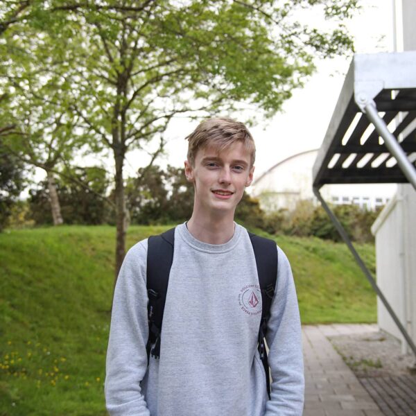 Harry stood outside of the college.