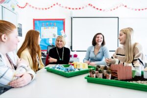 Students and a tutor in an early years class.