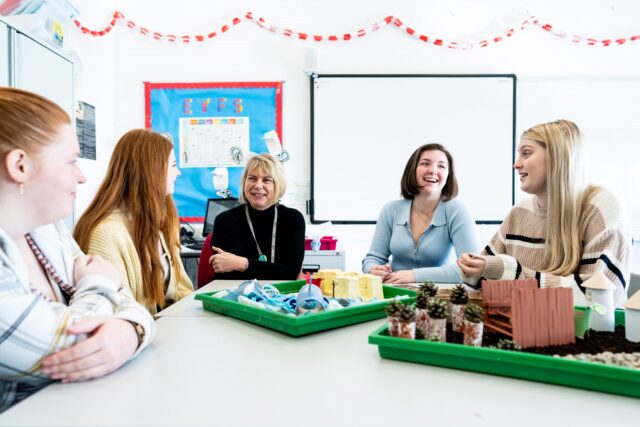 Students and a tutor in an early years class.
