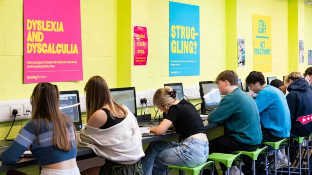 Students work at desks in front of computers in the quiet study area.