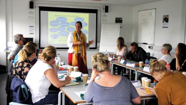 A classroom with mature students and a teacher.