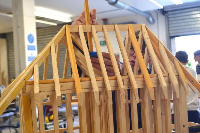 A close up of a small wooden structure.