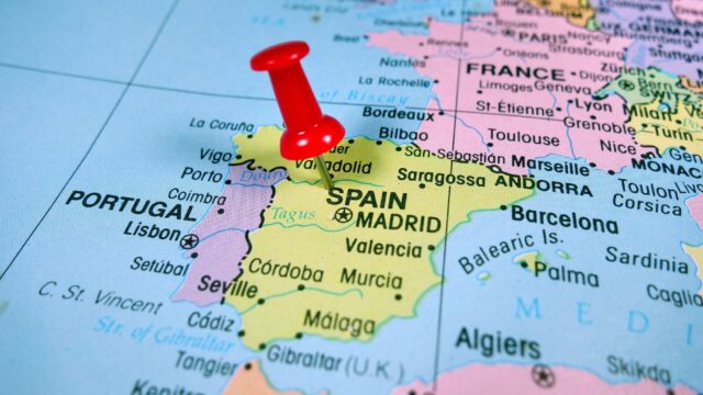 Pushpin marking on Spain map.