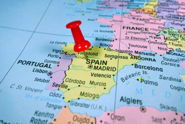 Pushpin marking on Spain map.