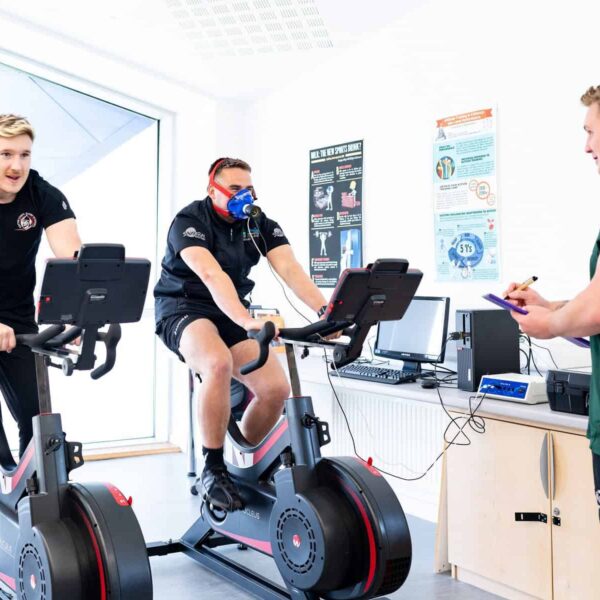 Three students use sports equipment.