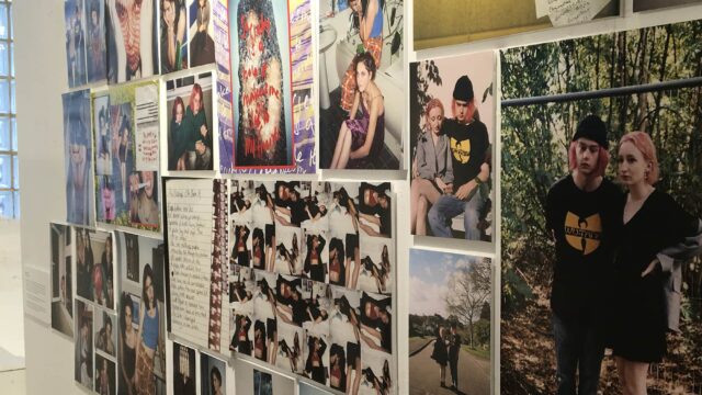 A collection of media posters on the wall.