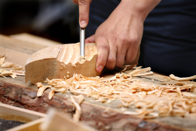 Woodcarver work in the workshop.