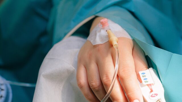 A close up of a hand with a tube attached to it.