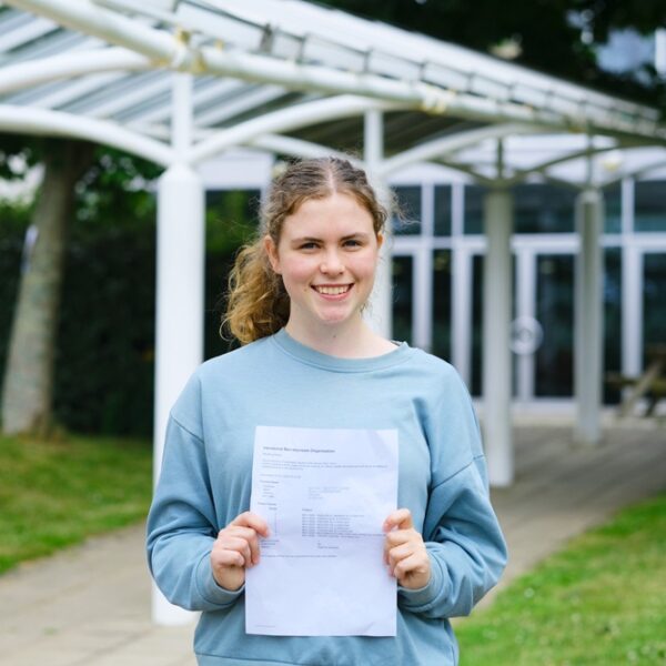 Lauren holds her results up and smiles.