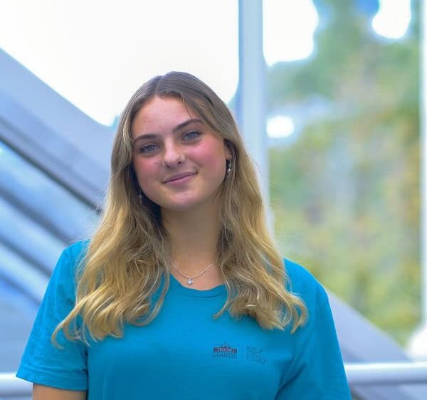 A student ambassador wearing a blue ambassador T shirt.