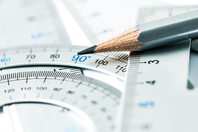 extremely selective focus a part of the silver pencil and precision measurement tool , concept of construction or building design drawing idea