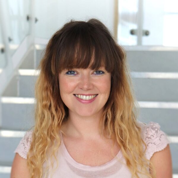 A photo of Lucy Maggs, she is wearing a pink t shirt.