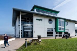 An image of the exterior of the White building at Truro campus on a sunny day.
