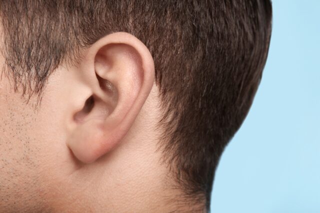 Young man, closeup of ear.