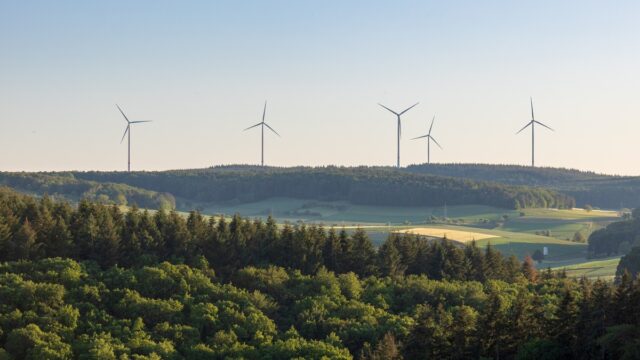 Wind Turbines At The Horizon In Green Rural Landscape In Werbach