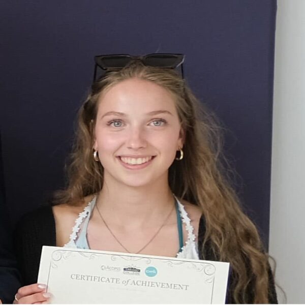 A photo of Maddy holding a certificate.
