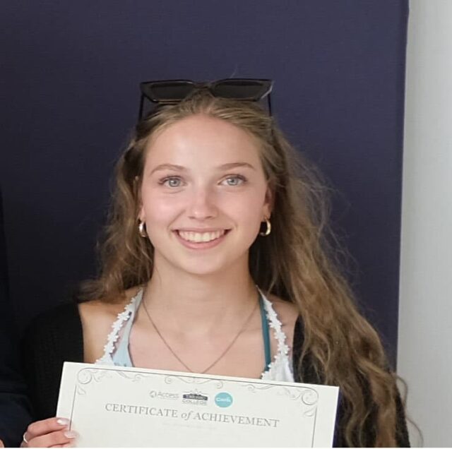 A photo of Maddy holding a certificate.
