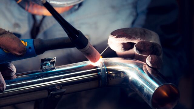A close up of welding on a metal pipe.