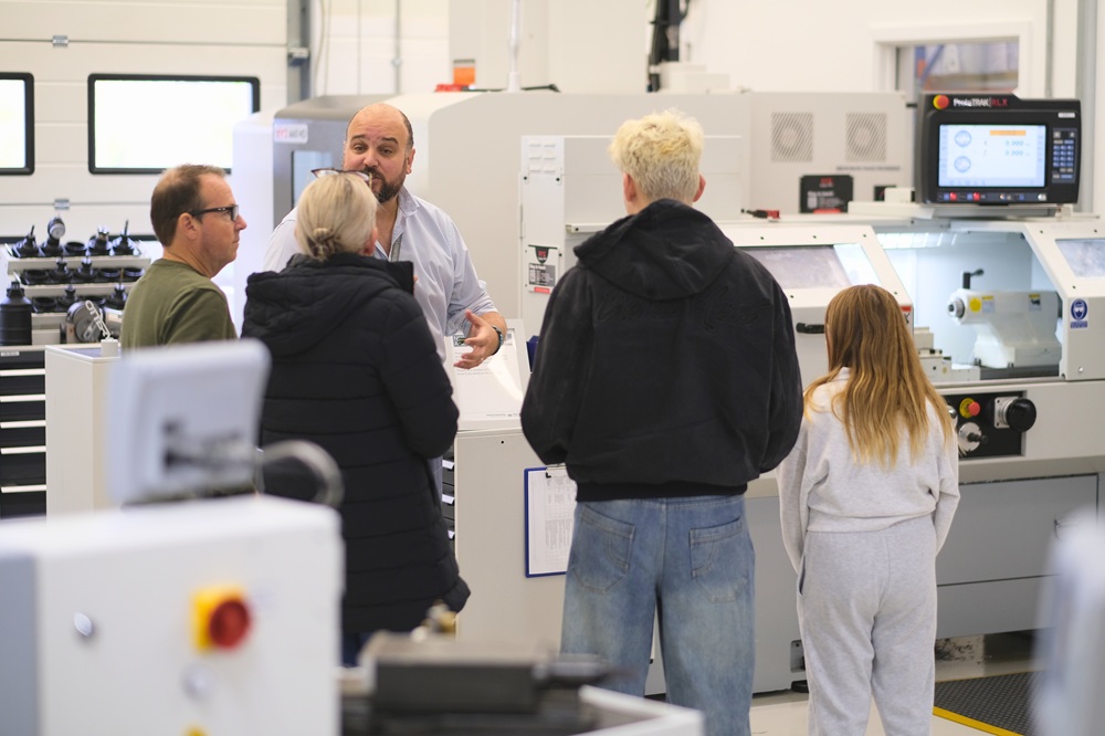 Members of the public chatting to a member of staff in the engineering bay at the STEM Centre