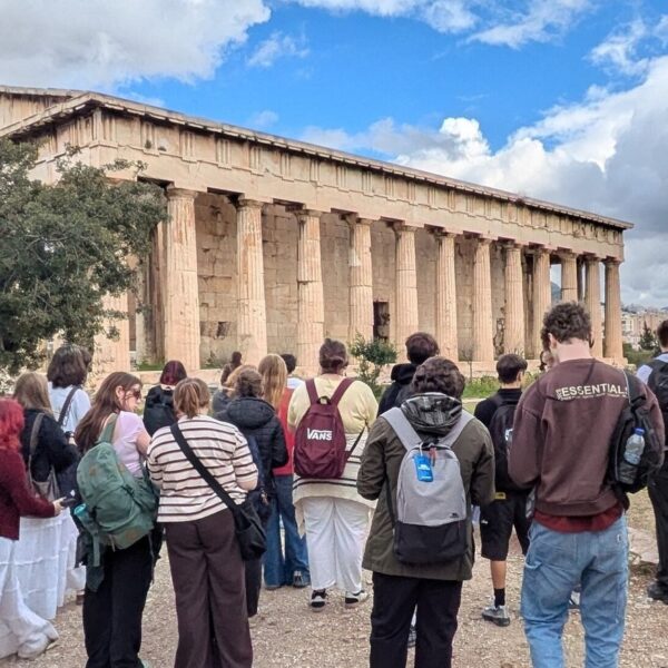 Students looking at a large monument in Greece.