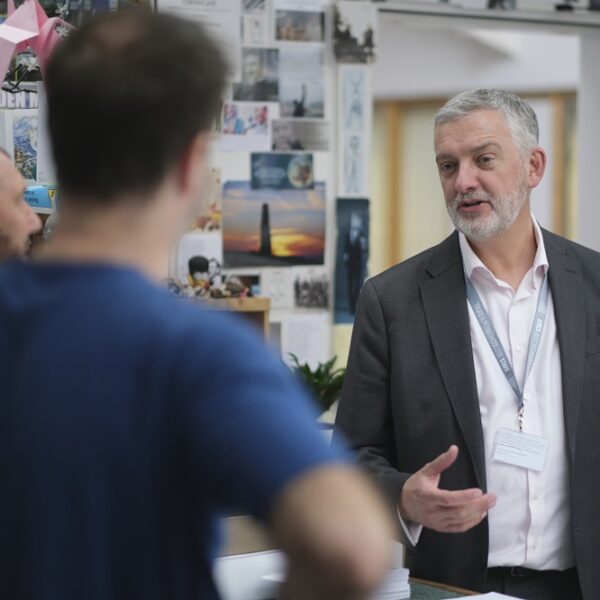 Principal Carl Riding chatting to two members of staff at the College.