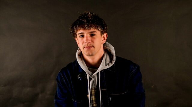 Barney sat against a dark backdrop.