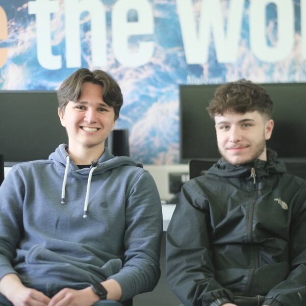 Riley and Kieran sat side by side in a computer room at the College.