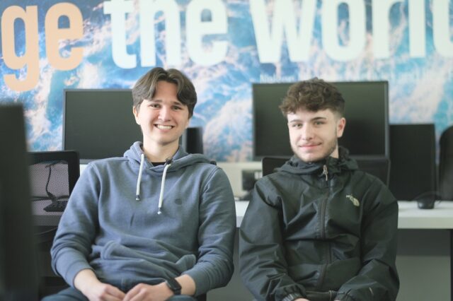 Riley and Kieran sat side by side in a computer room at the College.