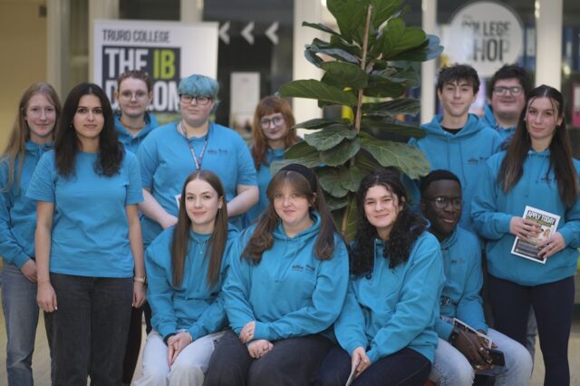 A group of student ambassadors in blue T shirts and hoodies gathered in the Career Zone.