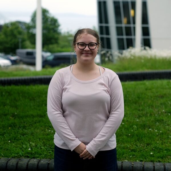 Edie Newman stood outside at the College with her hands in front of her.