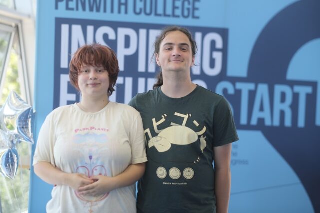 Charlie and Chloe stood side by side with a Penwith College banner and star balloons behind them.