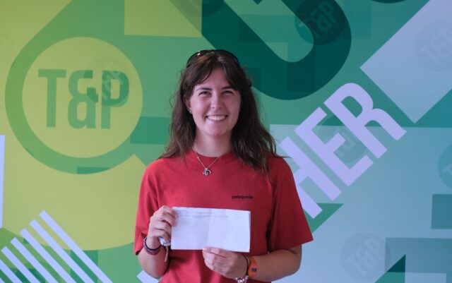 Mirryn against a Truro and Penwith green backdrop, holding up her results.