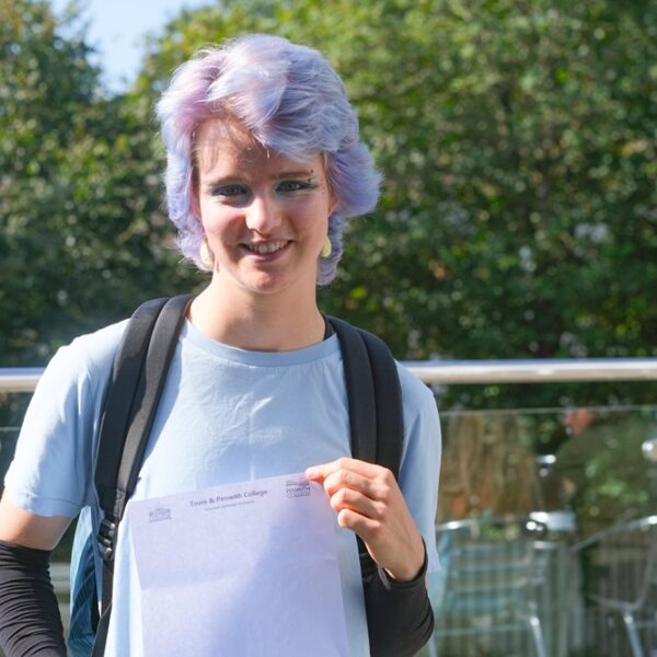 Ryn is holding up their results stood outside at Penwith College.