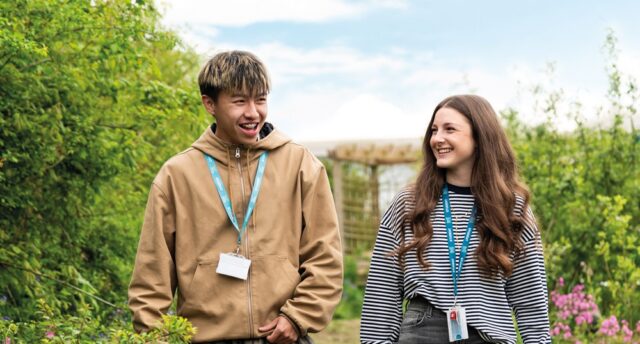 Two Callywith College students walking together, chatting and laughing.