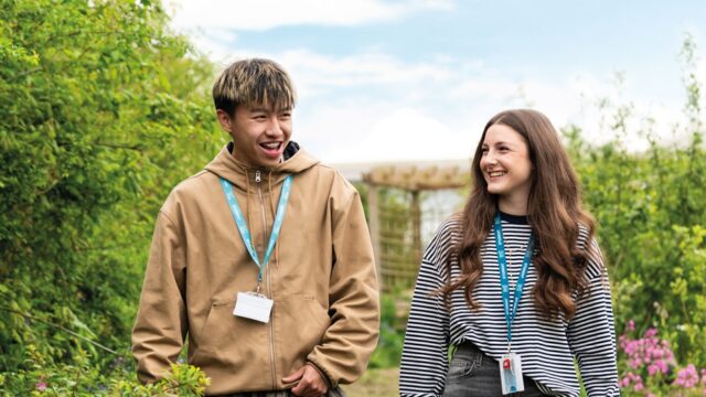 Two Callywith College students walking together, chatting and laughing.