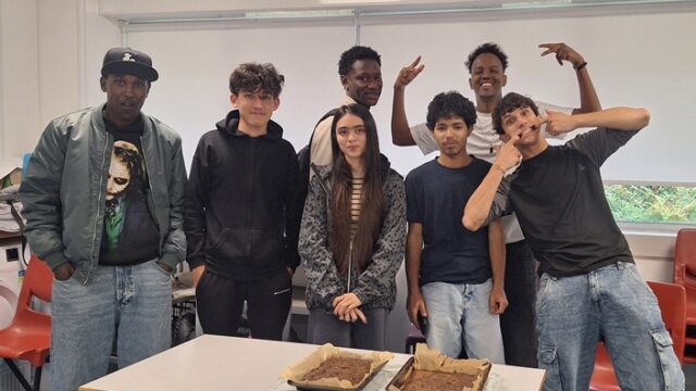 A group of students smile and make goofy faces at the camera.