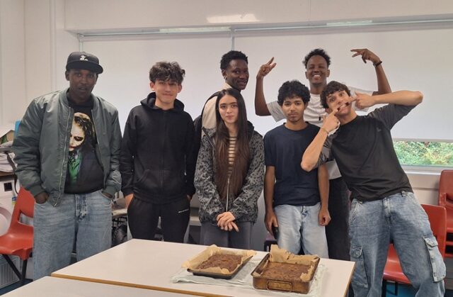 A group of students smile and make goofy faces at the camera.