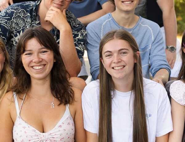Students sat on a bench outside the College on results day.